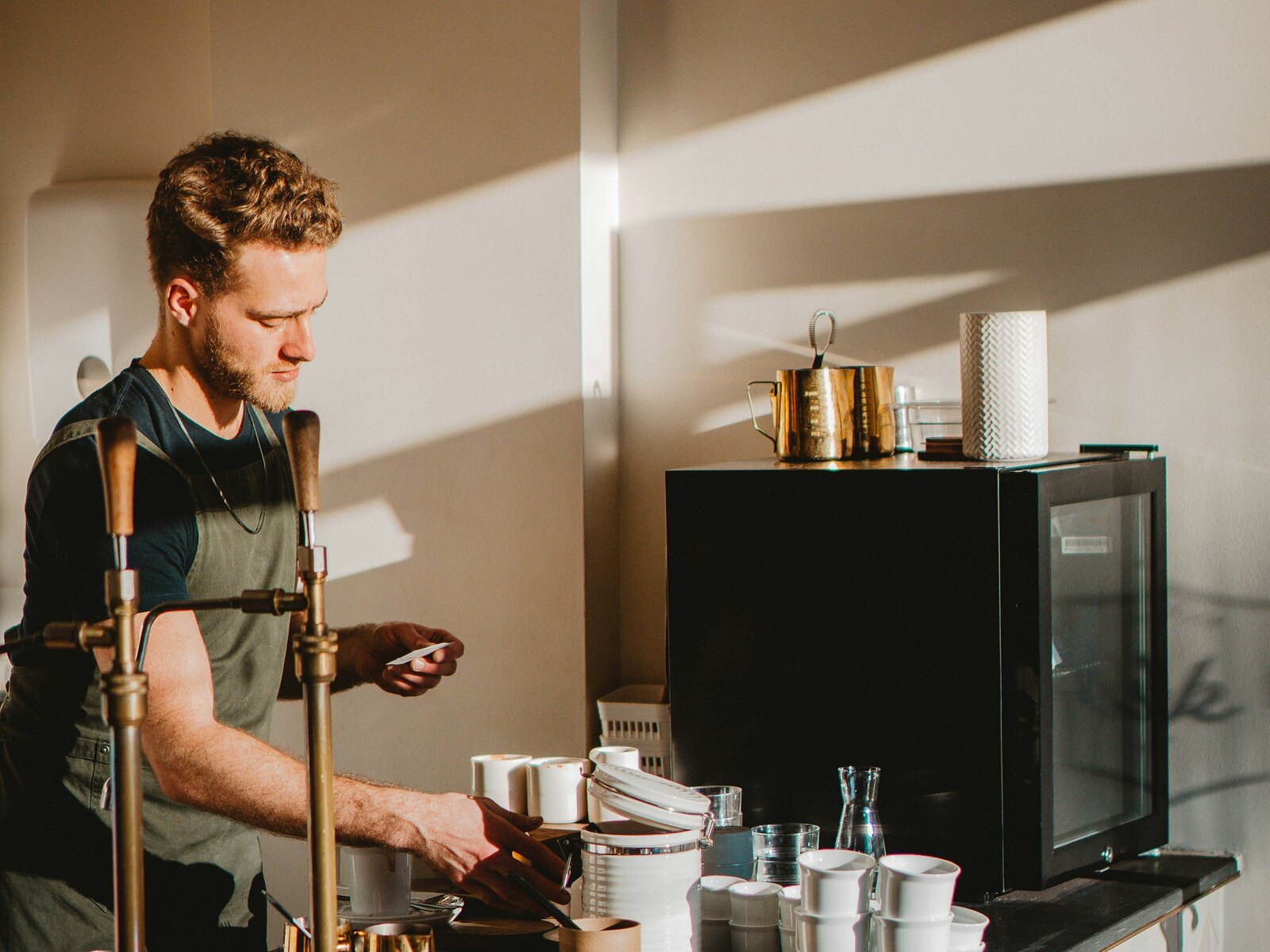A barista pouring espresso in a cafe